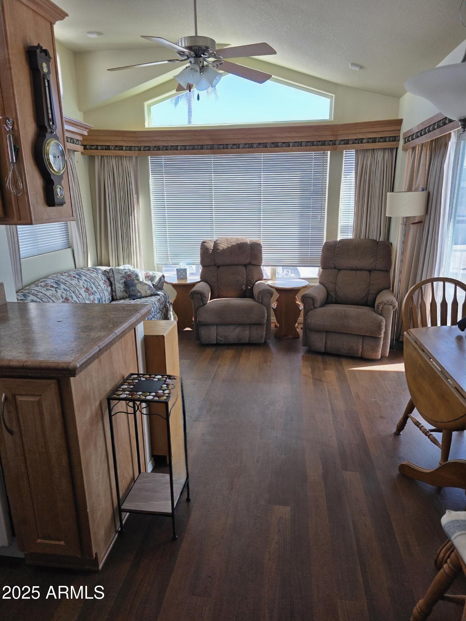 1347 West Inuit Avenue, Unit 347 Apache Junction, AZ 85119 - Photo 6 of 6 a living room with furniture and a flat screen tv