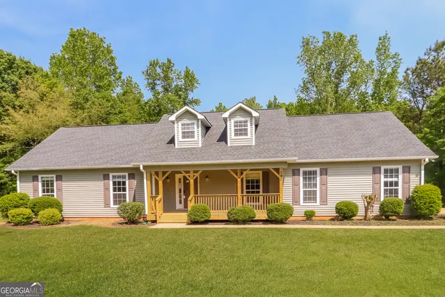a front view of a house with a garden and porch