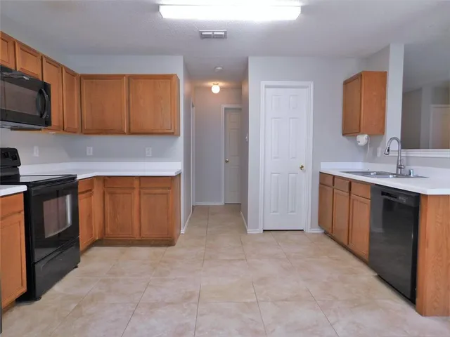 a view of a kitchen with a sink cabinets and wooden floor