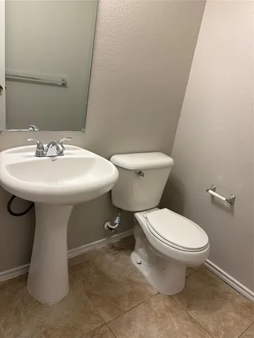a white toilet sitting next to a white sink