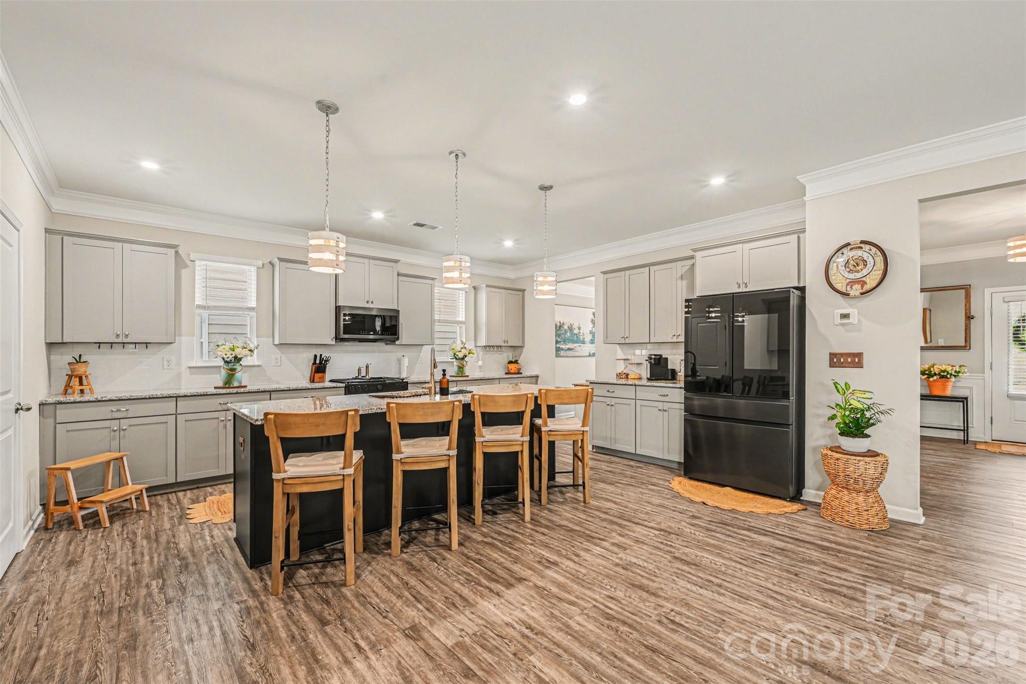 425 Kiser Lane Locust, NC 28097 - Photo 6 of 25 a large white kitchen with lots of wooden furniture a sink appliances and dining table