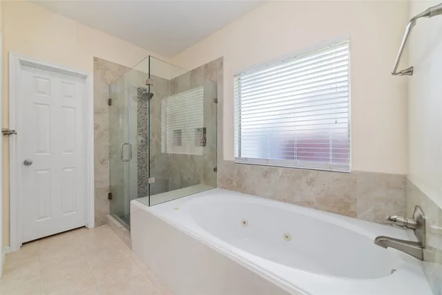 a bathroom with a bathtub and a shower