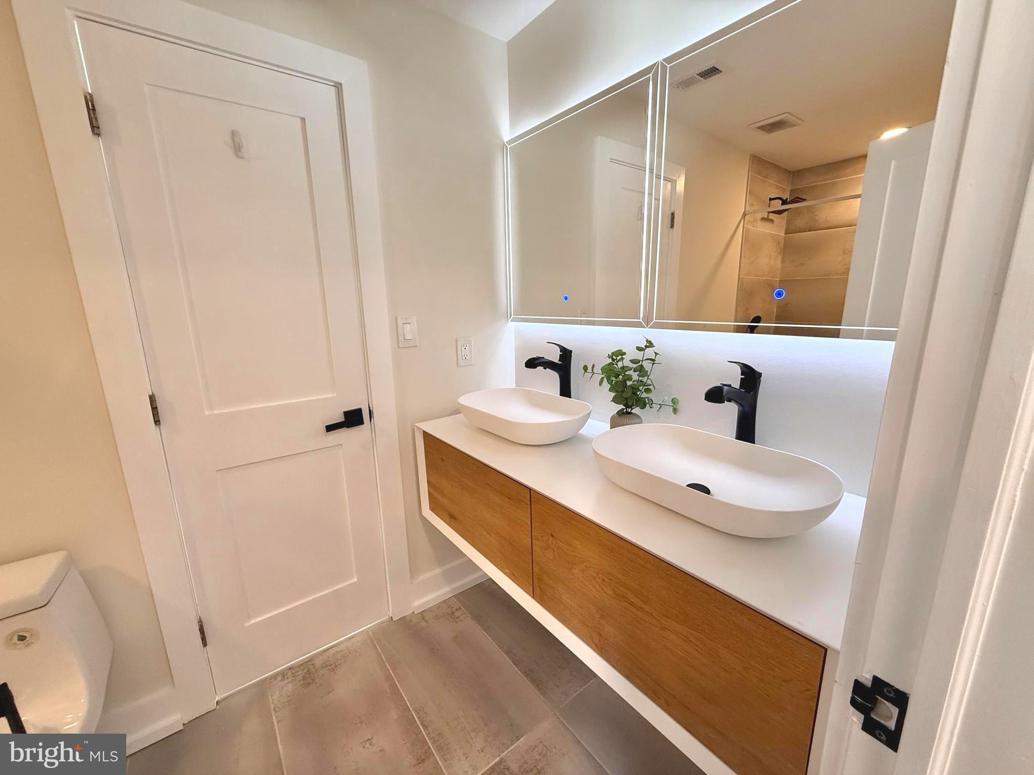 310 South Alfred Street Alexandria, VA 22314 - Photo 32 of 63 a bathroom with a sink a toilet and a mirror