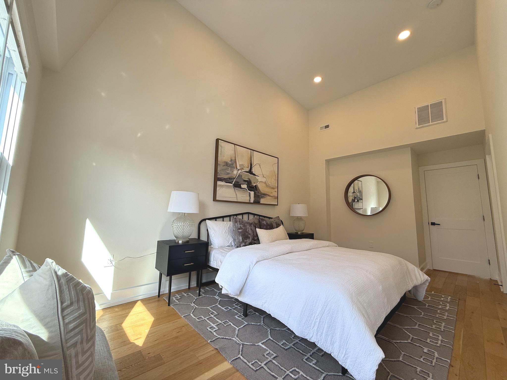 310 South Alfred Street Alexandria, VA 22314 - Photo 44 of 63 a bedroom with a bed and a lamp