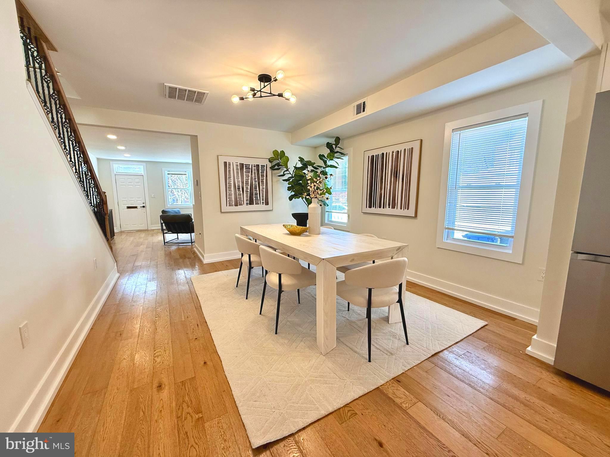 310 South Alfred Street Alexandria, VA 22314 - Photo 7 of 63 a dining room with wooden floor and large windows