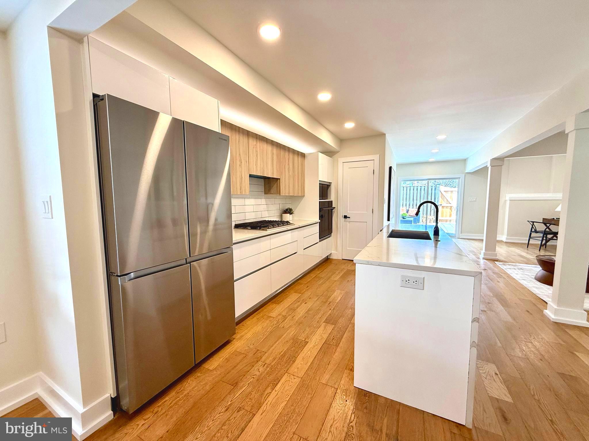 310 South Alfred Street Alexandria, VA 22314 - Photo 9 of 63 a kitchen with stainless steel appliances a refrigerator and a stove top oven