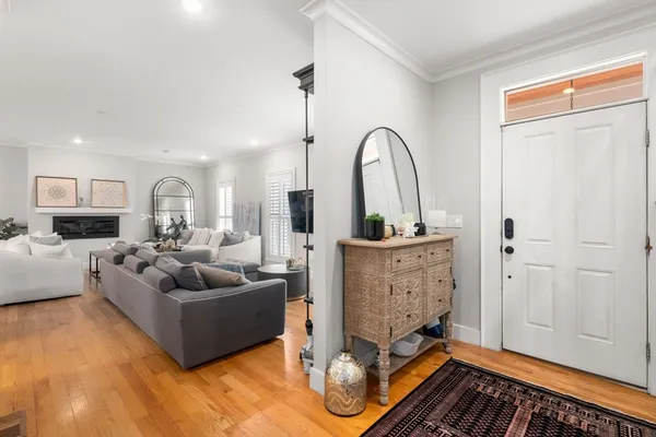 a living room with furniture a rug and a window