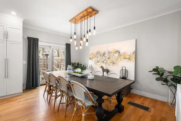 a view of a dining room with furniture window and wooden floor