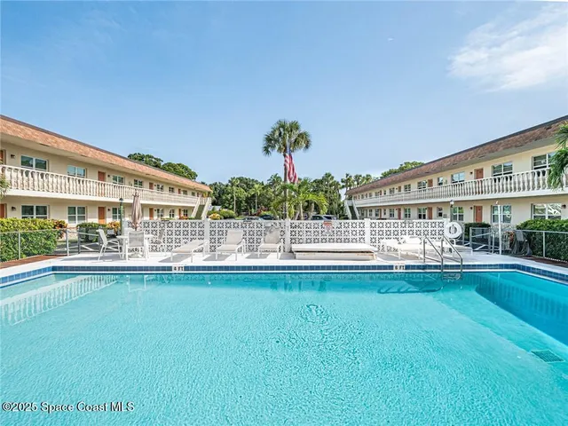 a view of building with swimming pool and outdoor seating