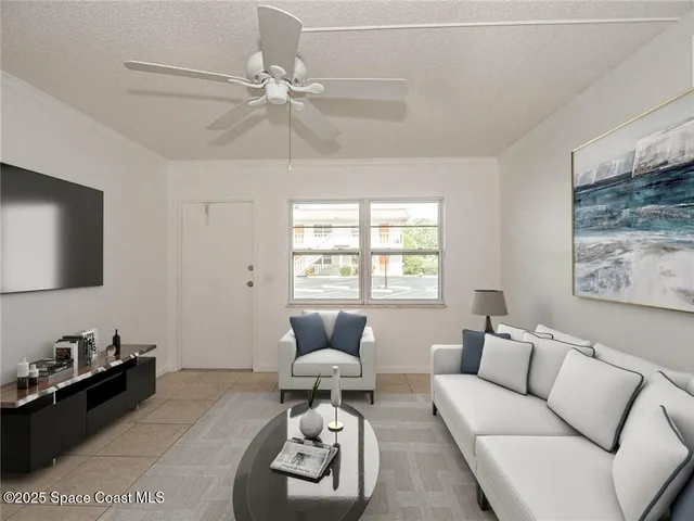 a living room with furniture a rug and a window