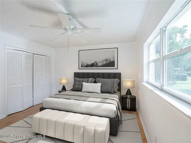 a bedroom with a large bed and a window