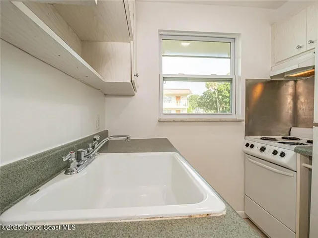 a bathroom with a tub sink and window