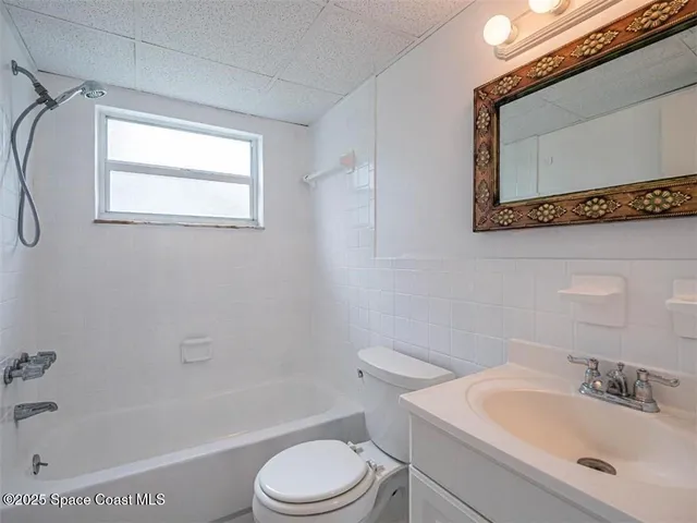 a bathroom with a sink a toilet and bathtub