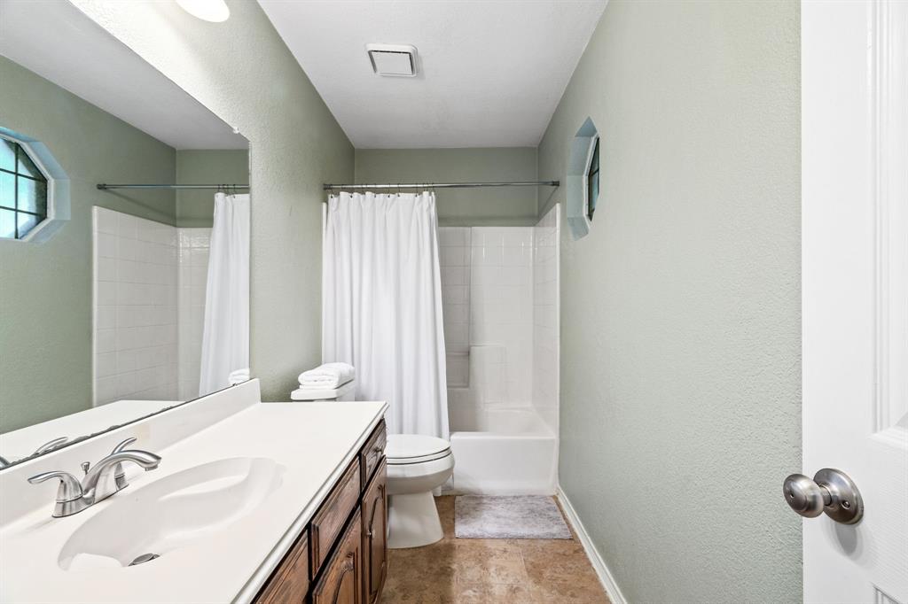 2302 Randi Road Rowlett, TX 75088 - Photo 20 of 33 a bathroom with a sink toilet and shower