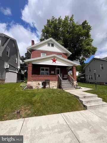 a view of house with garden and entertaining space