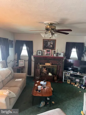 a living room with furniture fireplace and flat screen tv