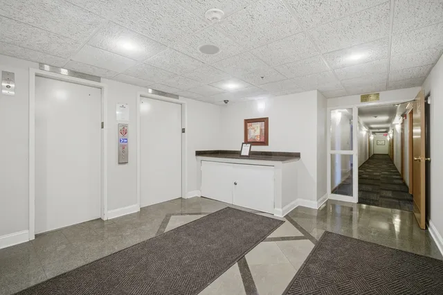 a view of a hallway with kitchen