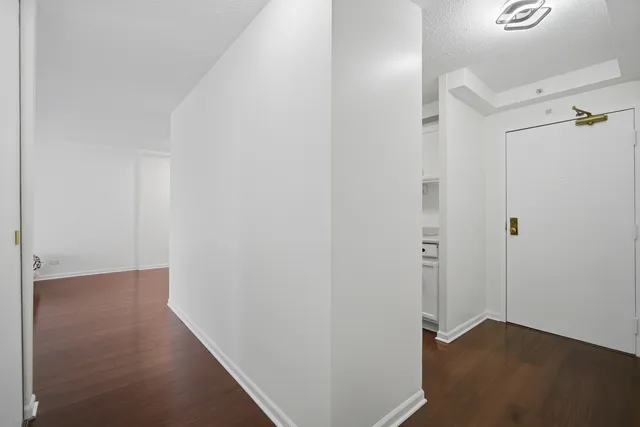 a view of a hallway with wooden floor