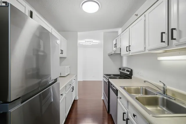 a kitchen with a sink stove and cabinets