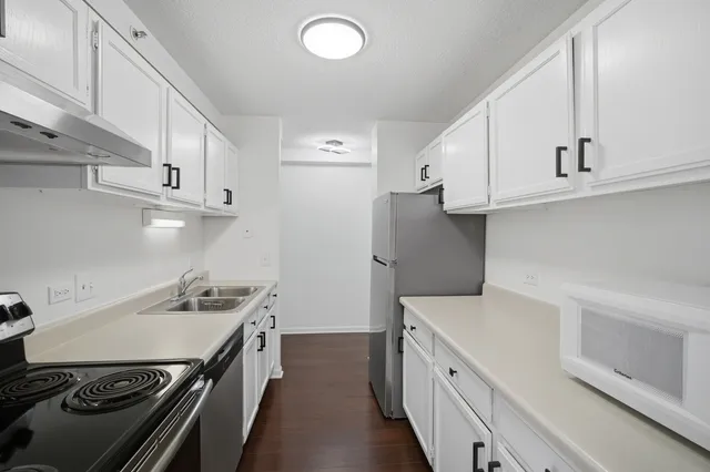 a kitchen with a stove and a refrigerator