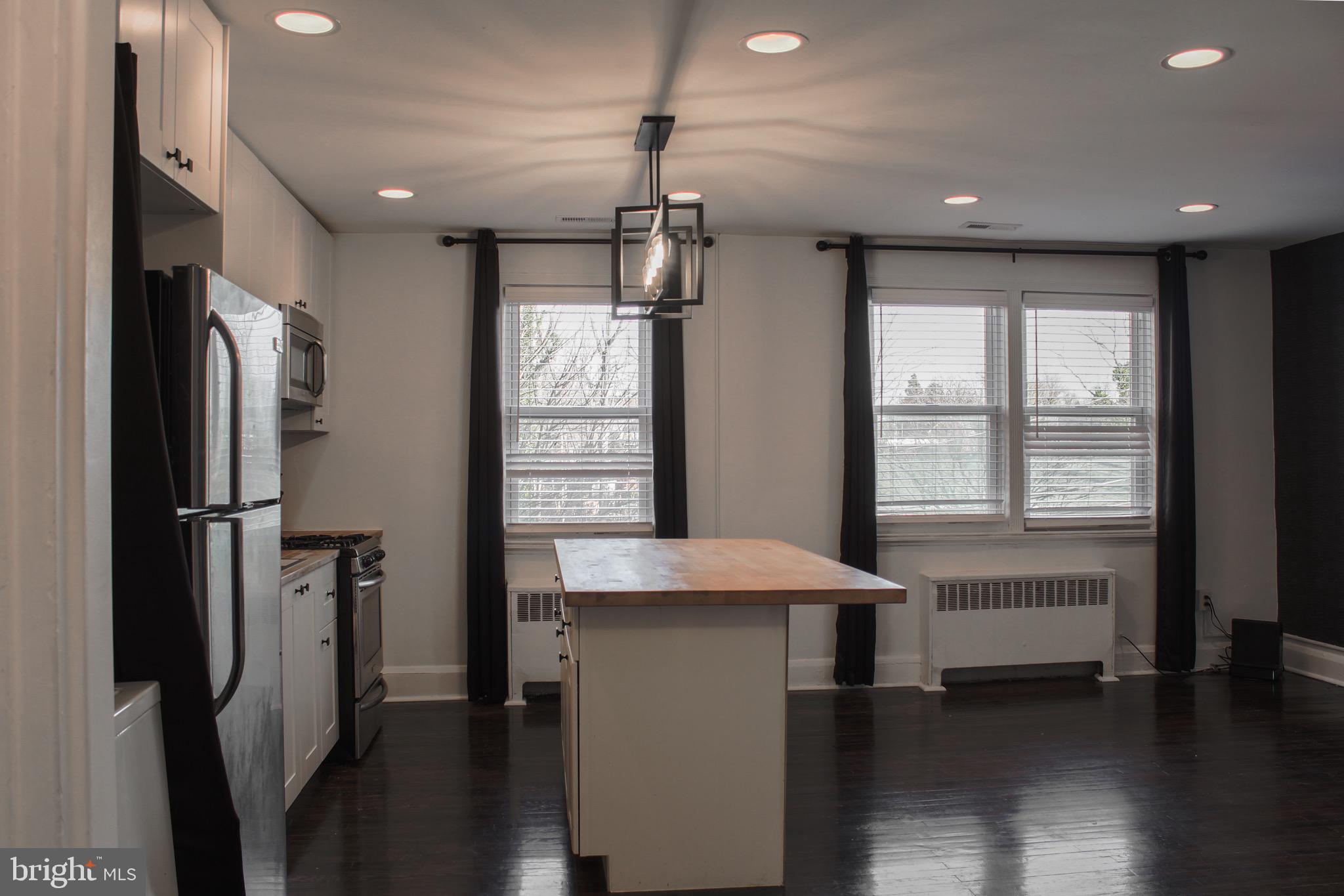 6161 Parkway Drive, Unit 2 Baltimore, MD 21212 - Photo 11 of 24 a view of a kitchen with refrigerator and wooden floor