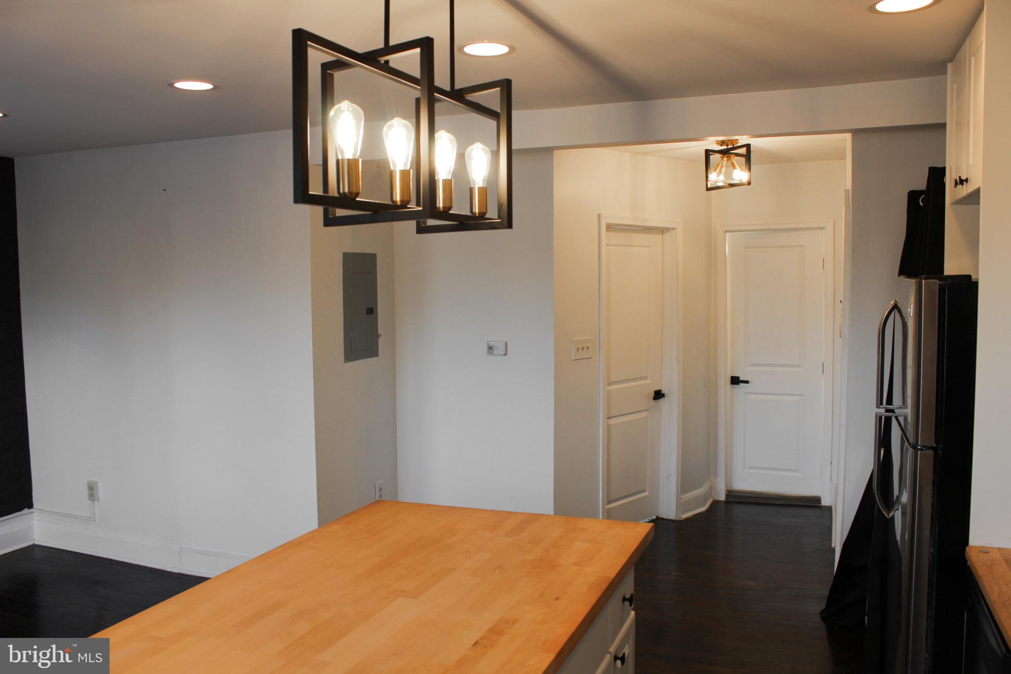 6161 Parkway Drive, Unit 2 Baltimore, MD 21212 - Photo 7 of 24 a bedroom with a bed and a mirror