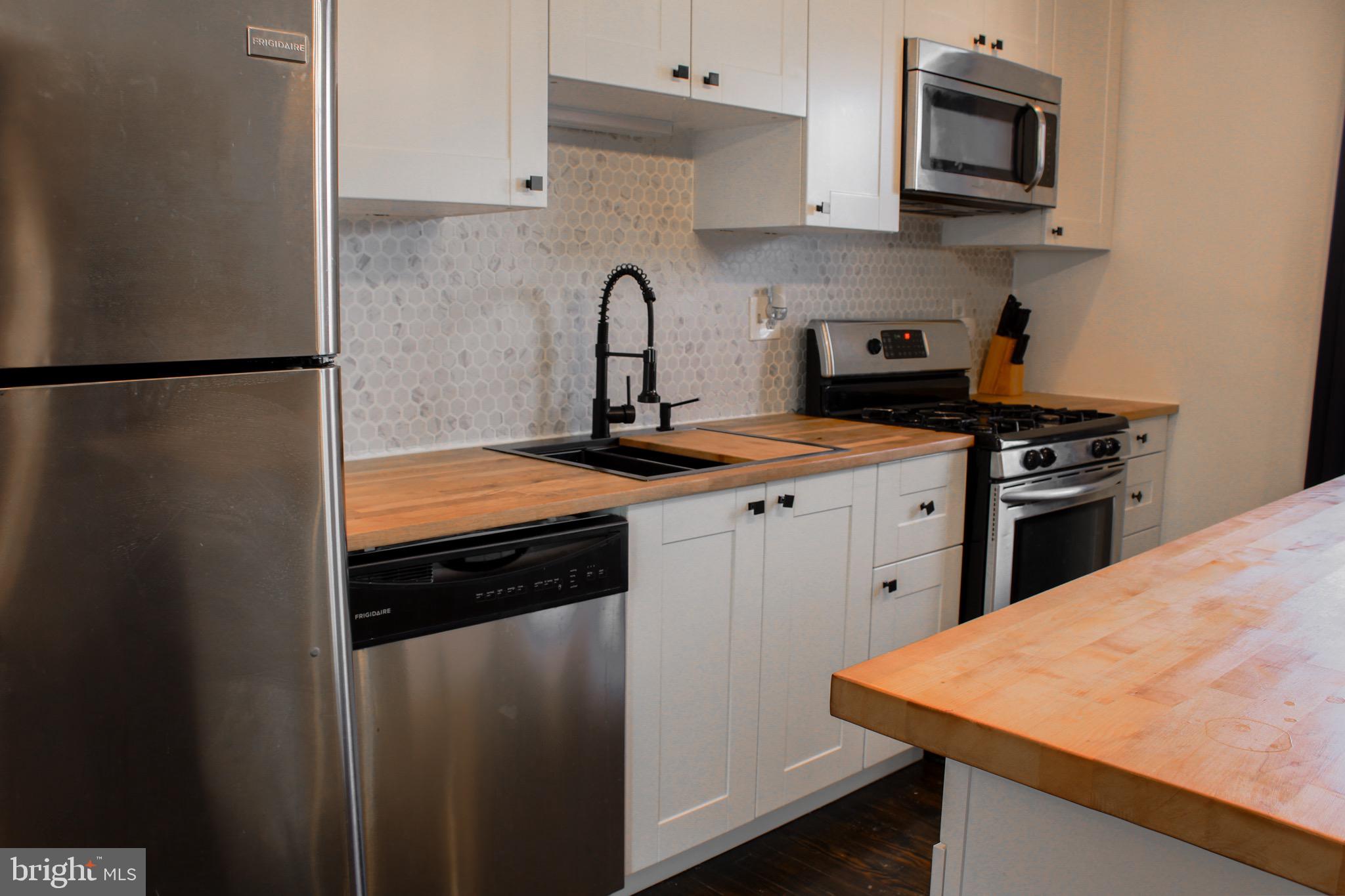 6161 Parkway Drive, Unit 2 Baltimore, MD 21212 - Photo 8 of 24 a kitchen with stainless steel appliances granite countertop a sink stove and refrigerator