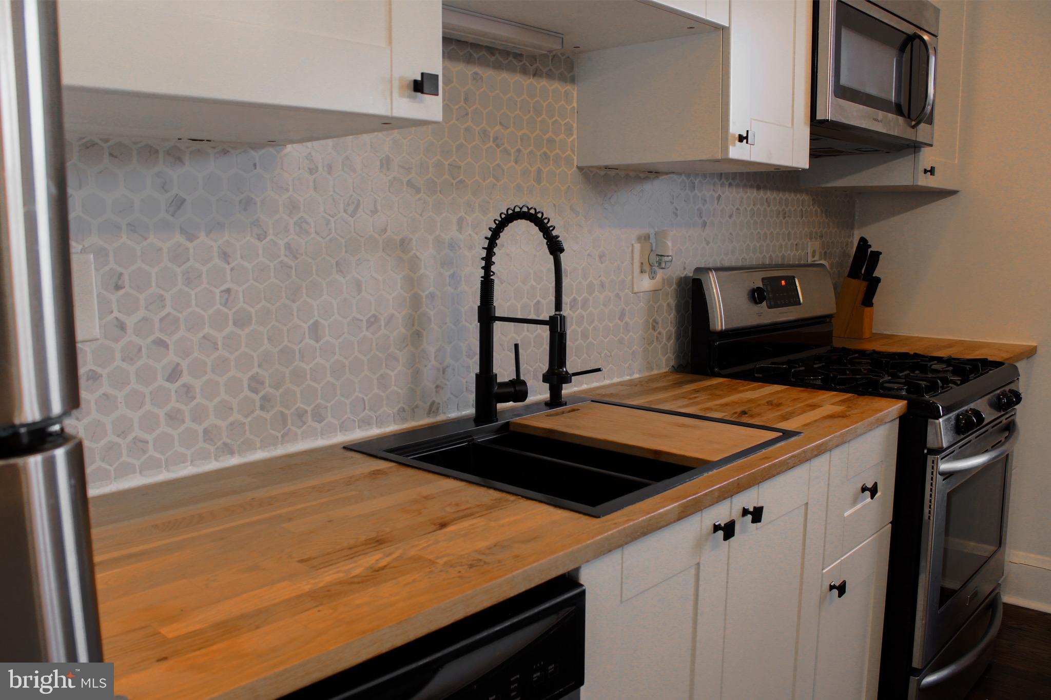 6161 Parkway Drive, Unit 2 Baltimore, MD 21212 - Photo 9 of 24 a kitchen with a stove and a microwave