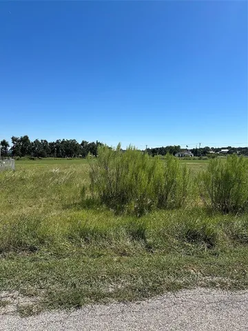 a view of a lake with houses in the back