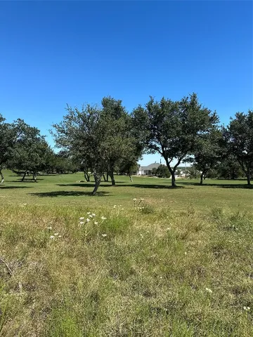 a view of field with trees in the background