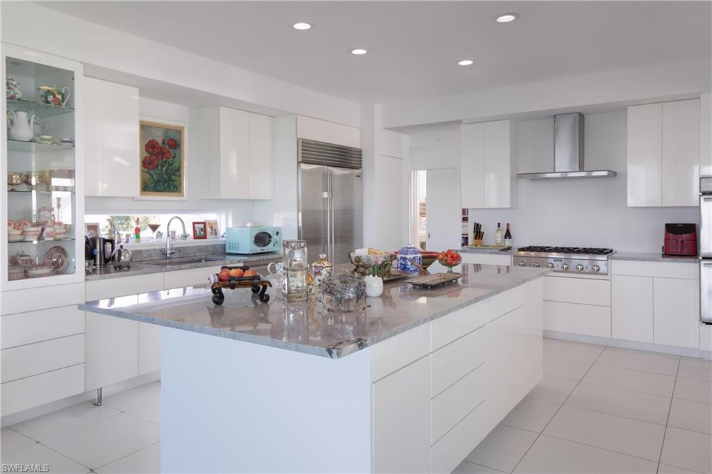14040 Schultz Road Fort Myers, FL 33908 - Photo 14 of 48 Kitchen with modern cabinets, white cabinets, light stone counters, and recessed lighting