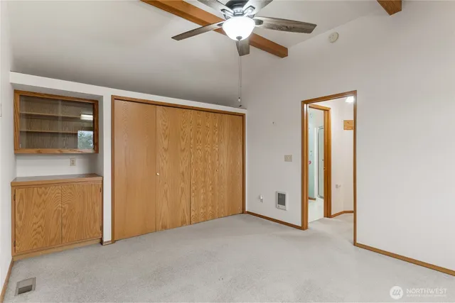 a view of a kitchen with refrigerator and cabinets