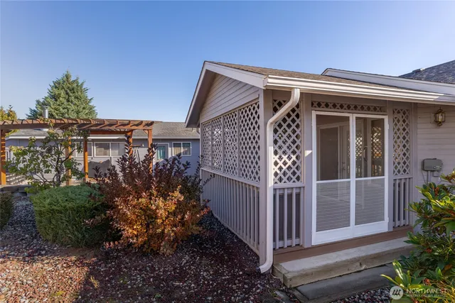 a view of a backyard with plants and outdoor seating