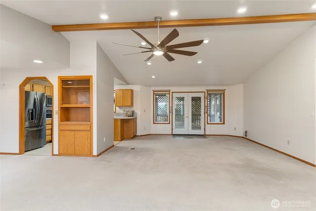 a view of an empty room with a cabinet and a window