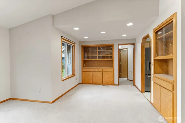 a kitchen with stainless steel appliances a refrigerator a sink a stove a microwave and cabinets