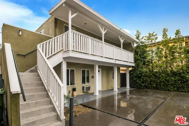 a view of a white building with many windows