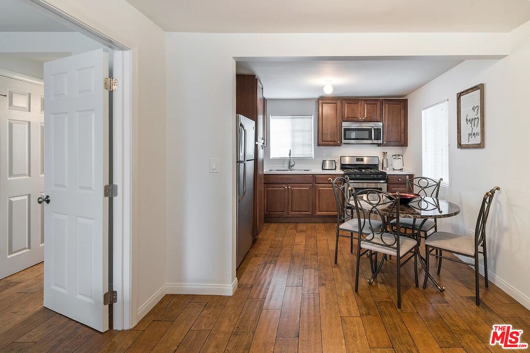 a view of a dining room with furniture and wooden floor