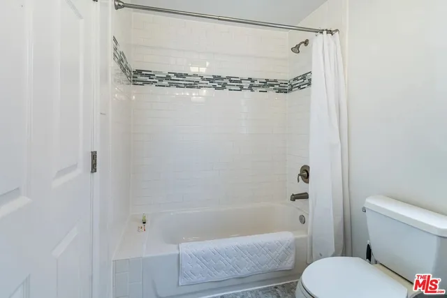 a bathroom with a shower and a toilet