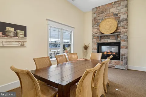 a dining room with furniture and a fireplace
