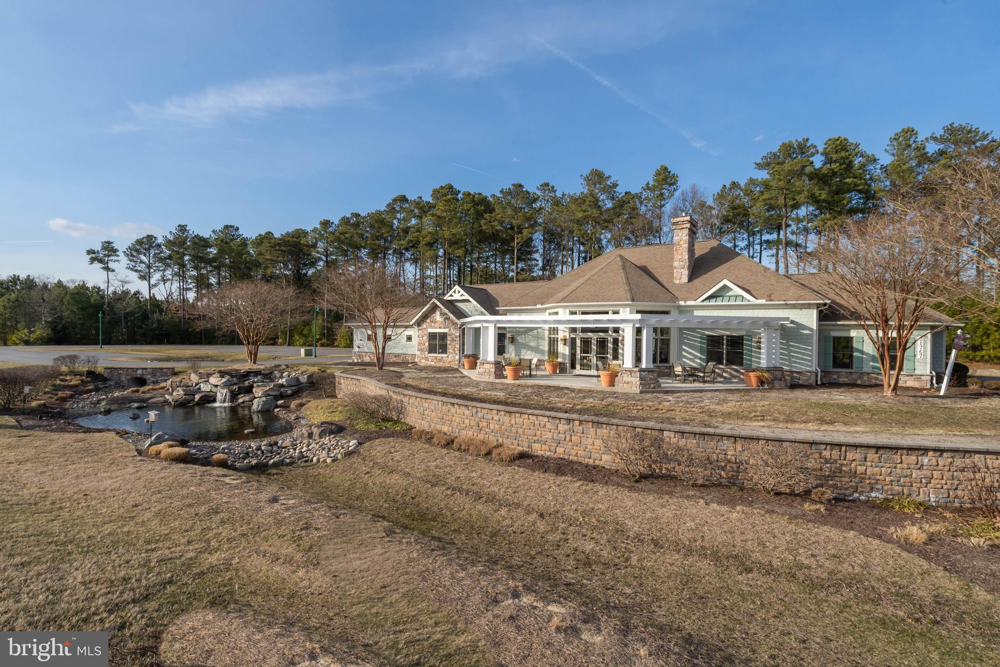 31896 Shell Landing Way Lewes, DE 19958 - Photo 23 of 26 a view of a white house with a yard and sitting area