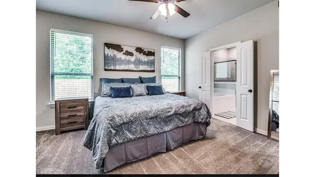 a bedroom with a bed and a painting on the wall