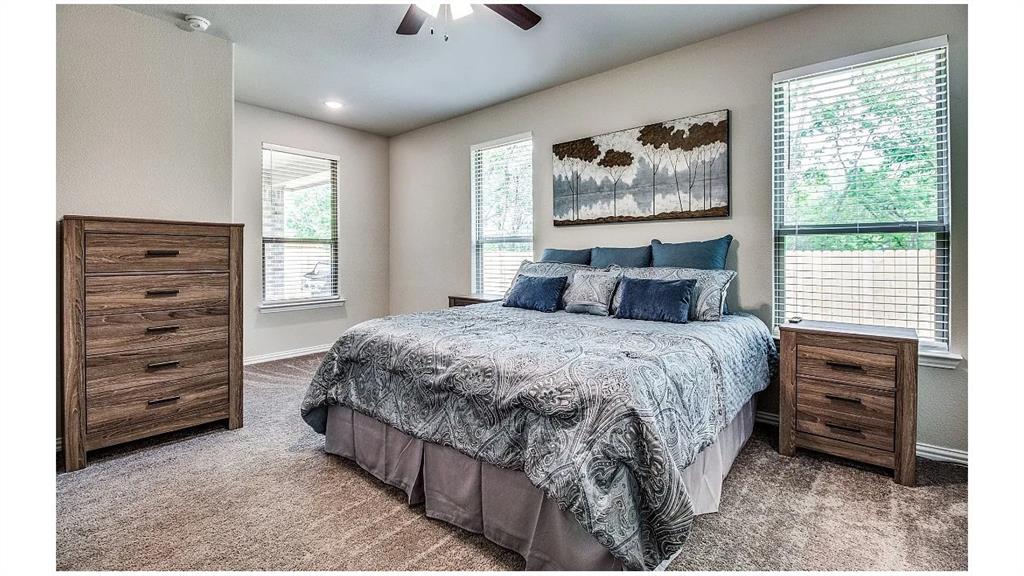 709 Copley Street Sherman, TX 75090 - Photo 12 of 27 a bedroom with a bed and a window