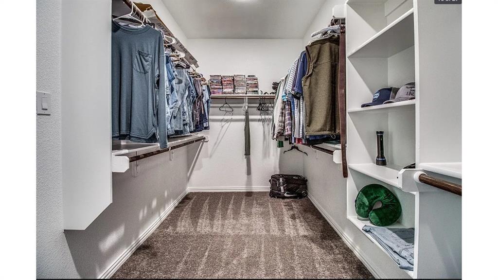 709 Copley Street Sherman, TX 75090 - Photo 16 of 27 a view of walk in closet with clothes and shoes