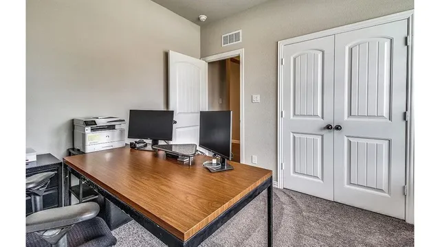 a view of a workspace with furniture