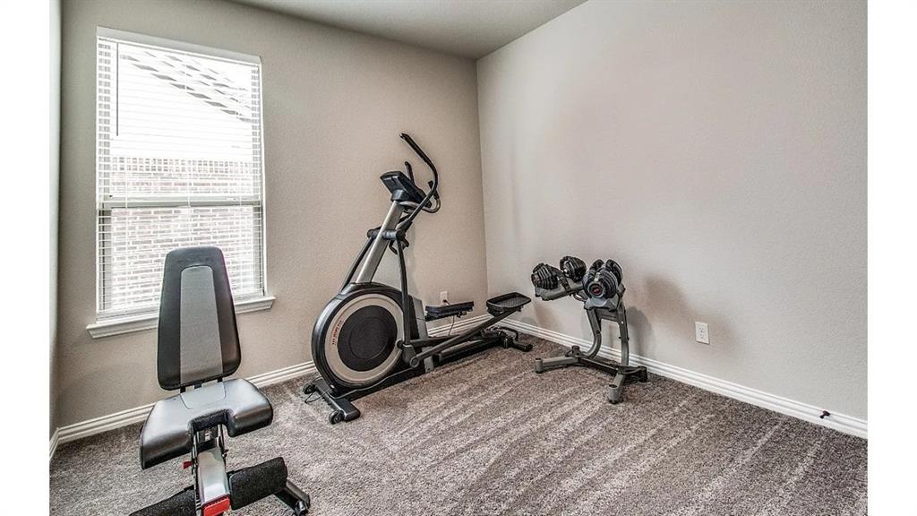 709 Copley Street Sherman, TX 75090 - Photo 20 of 27 a view of a room with gym equipment