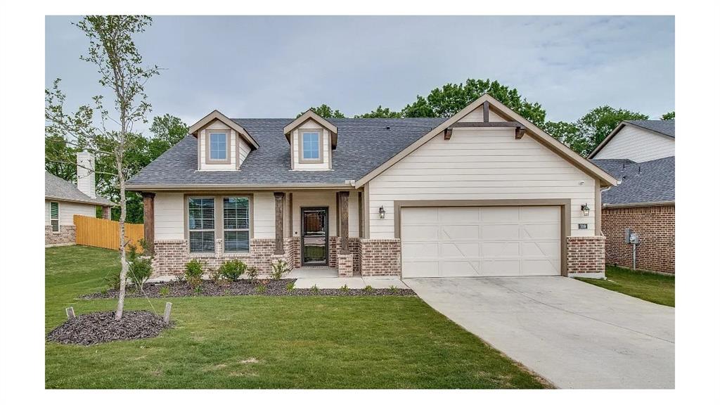 709 Copley Street Sherman, TX 75090 - Photo 2 of 27 a front view of a house with a yard and garage