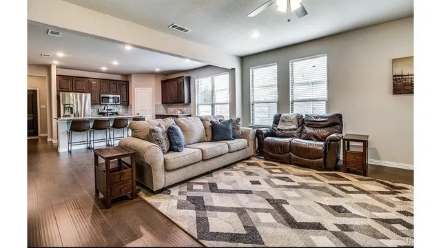 a living room with furniture and a rug