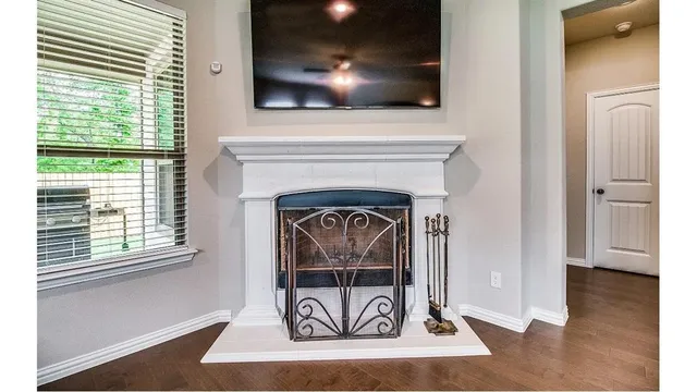 a living room with a fireplace and a flat screen tv