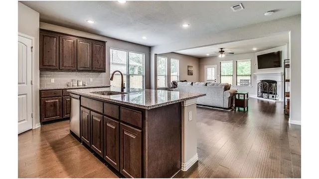 a kitchen with counter top space a sink appliances and cabinets