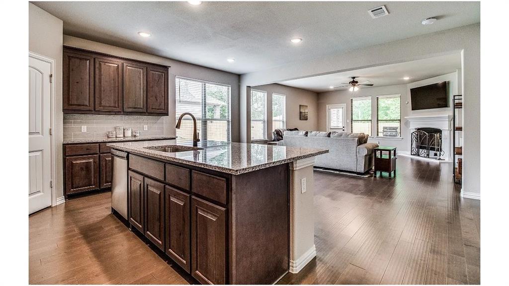 709 Copley Street Sherman, TX 75090 - Photo 7 of 27 a kitchen with counter top space a sink appliances and cabinets